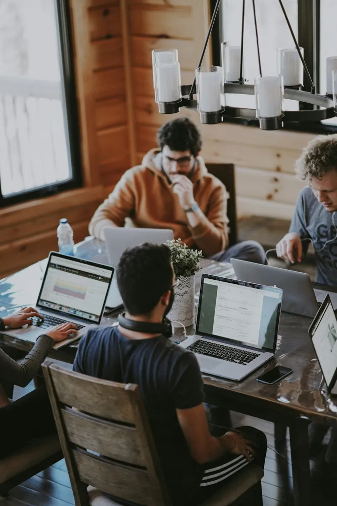 Business professionals collaborating around a shared worktable